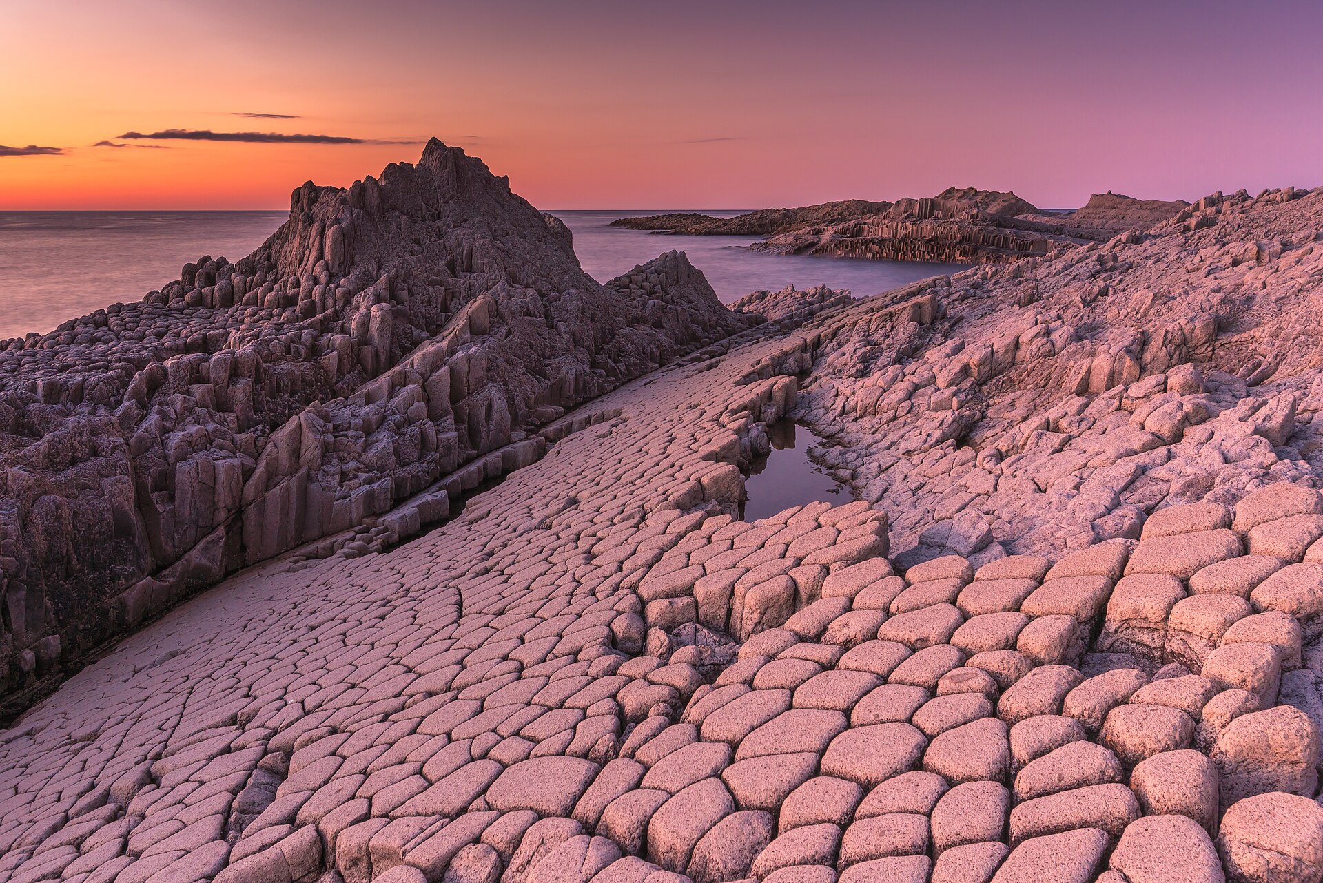 Columnar basalt formations at Cape Stolbchaty, Kunashir Island, after sunset