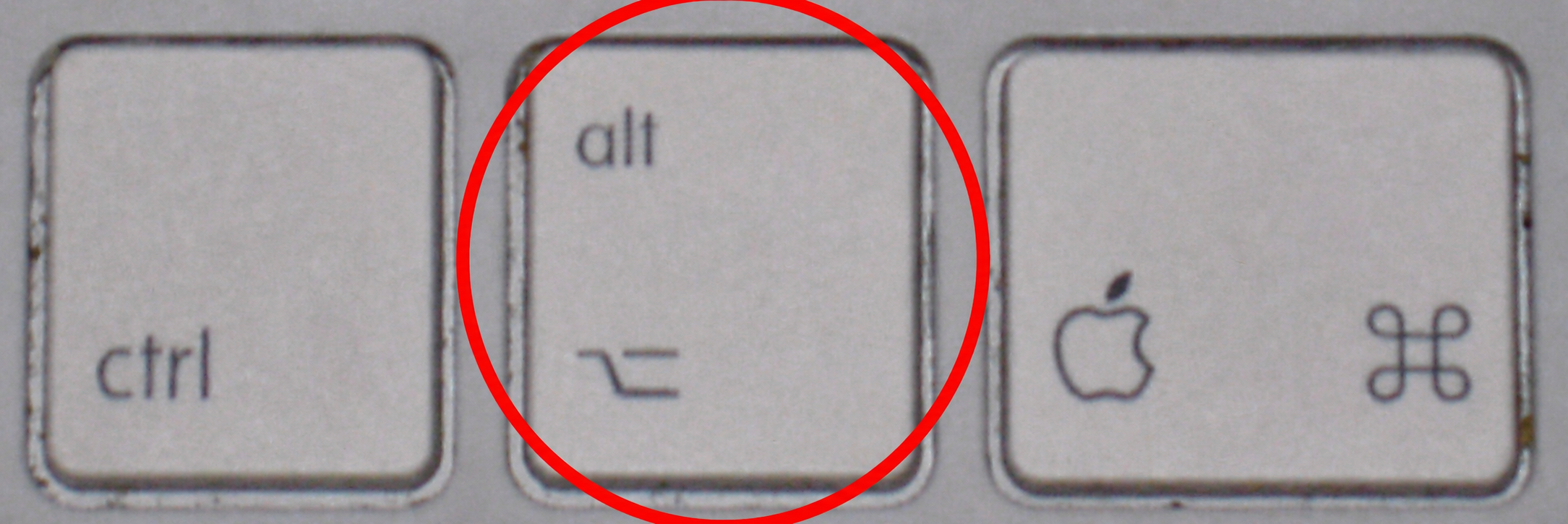 Mac keyboard with the left option alt key circled