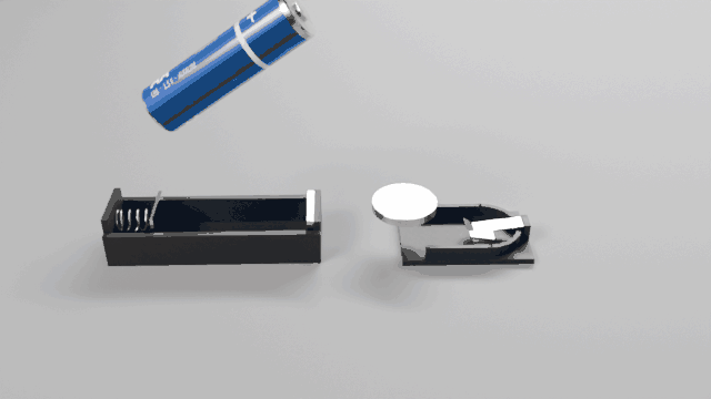 An AA cell and a CR2032 pushed into their holders