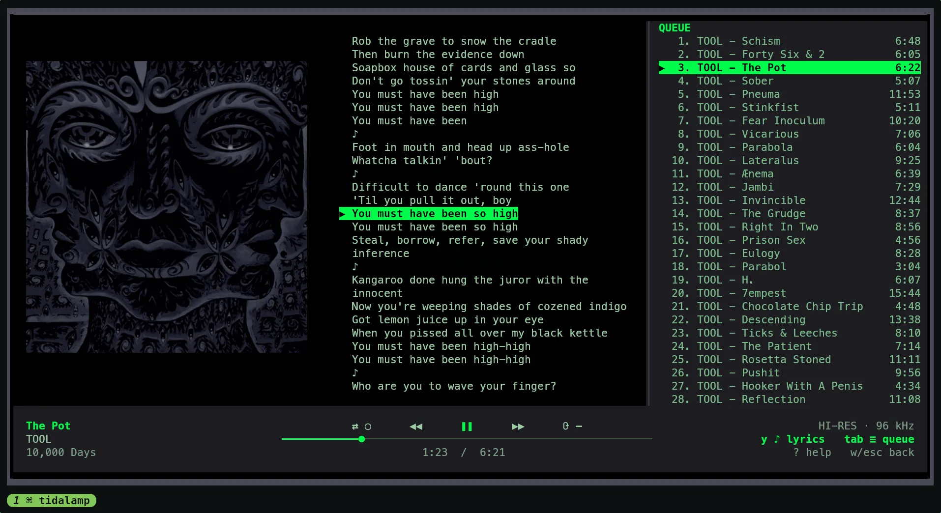 The same view with the lyrics and the queue open: the cover on the left, the words of the song in the middle with the sung line highlighted, and the queue on the right